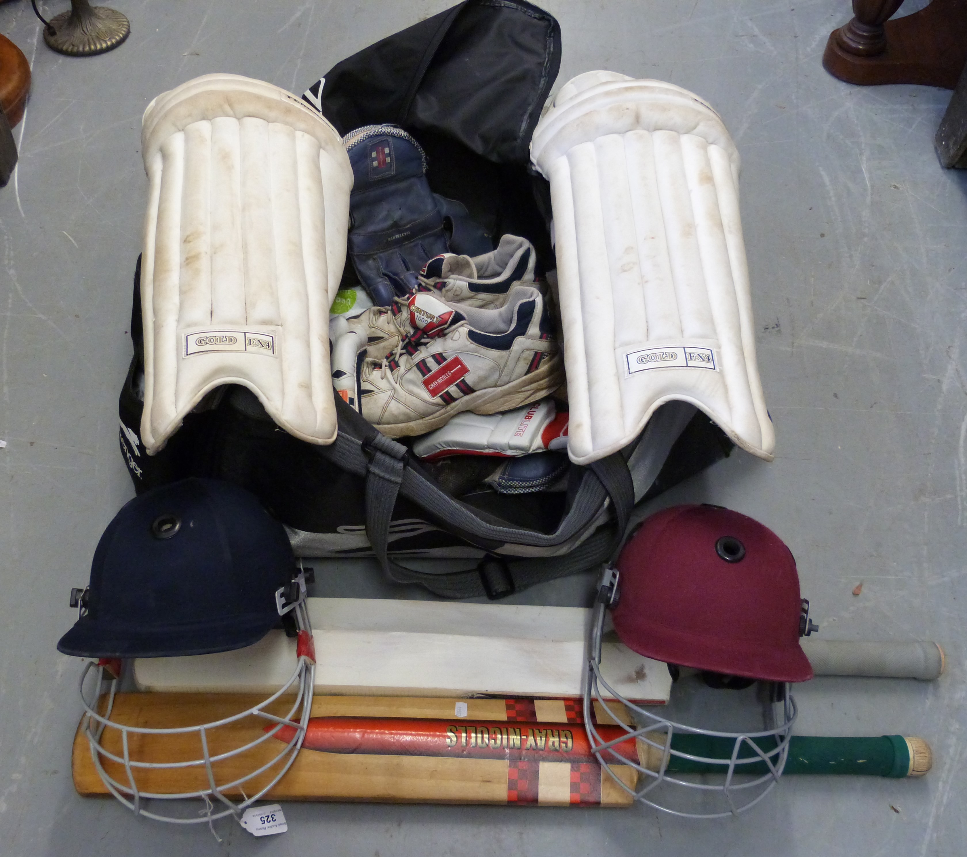 A quantity of cricketing equipment including two bats,