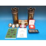 A pair of trench art brass shell cases together with three travelling clocks,