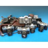 A quantity of SLR cameras comprising two Pentax and three Zenit together with a Zeiss Ikon TLR