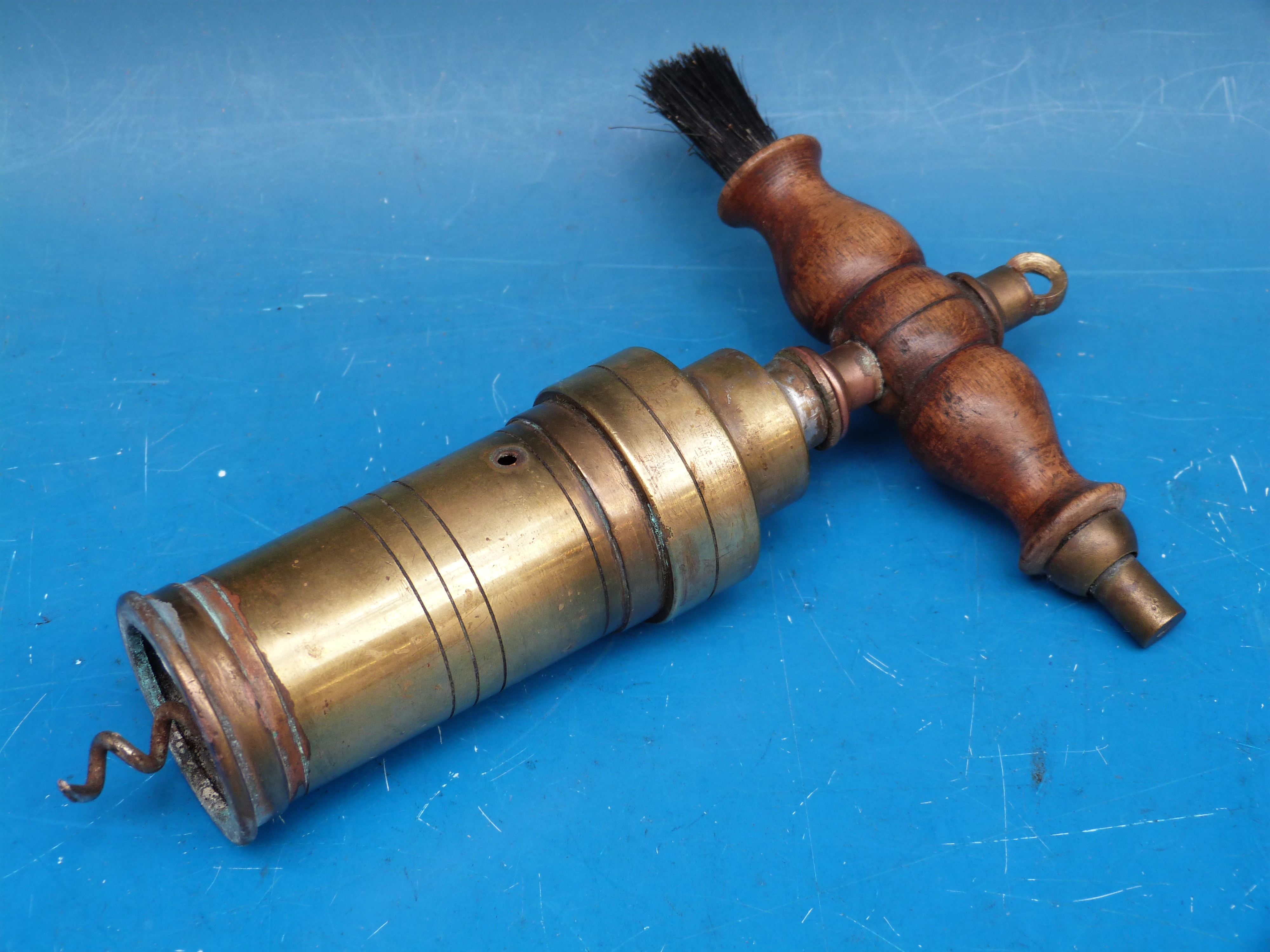 A 19thC brass barrel shaped corkscrew with wooden brush handle