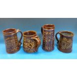 Four Peter Brown 'snake pottery' slip-ware mugs to include a 'toad' mug, a 1977 Jubilee example,