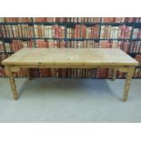 A solid pine kitchen table raised on turned legs