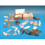 A collection of archeological finds with notes, including Roman buckle, glass,