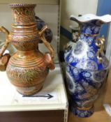 A Tiffany style table lamp together with an oriental style vase lamp and two large decorative vases