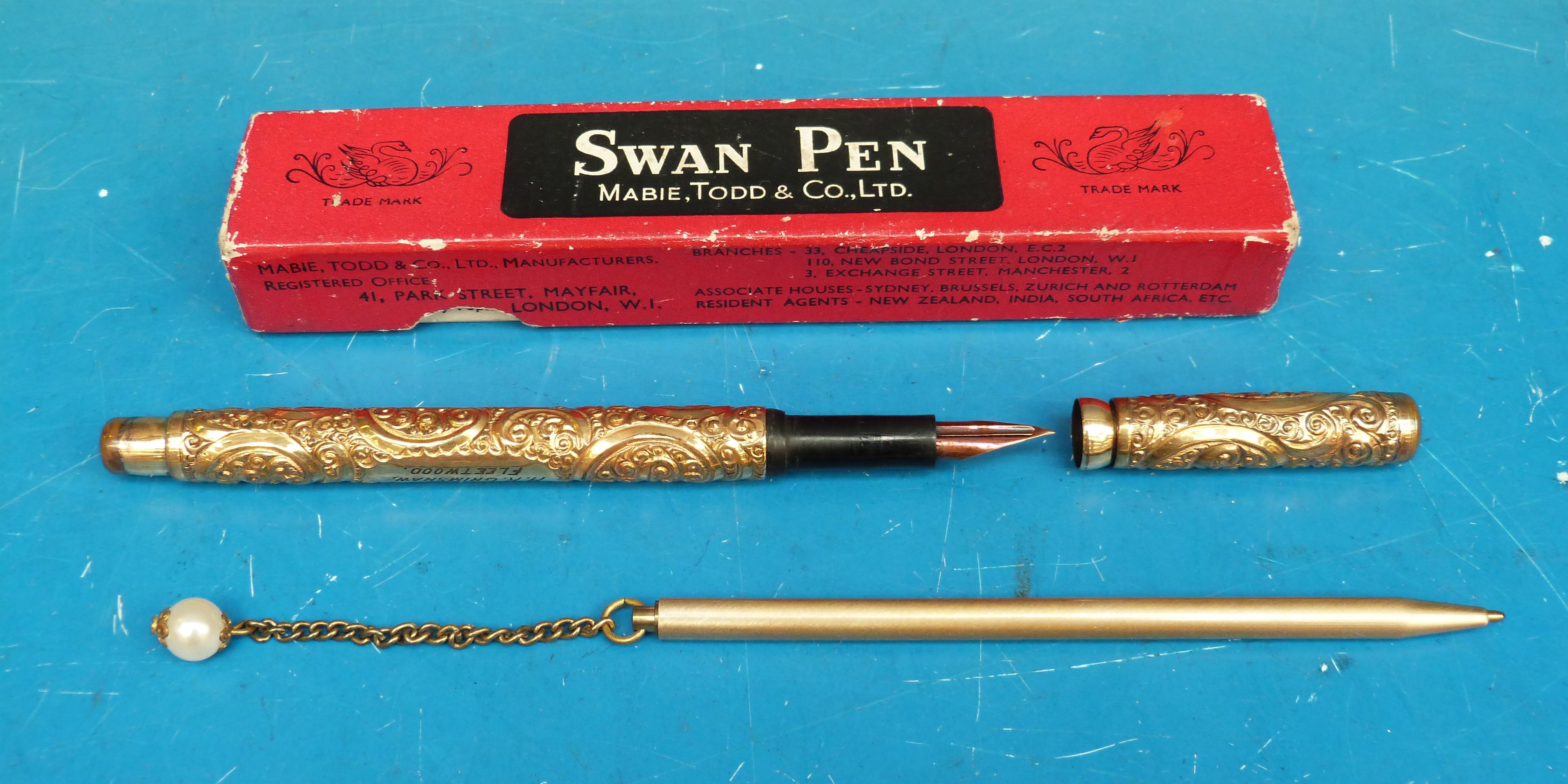 A boxed gilt swan pen with chased decoration,