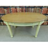 An oval beech kitchen table with single drawer and painted base (L146 x W90 x H77cm)