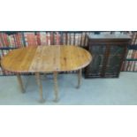 A glazed display cabinet with two shelves together with a pine drop leaf table