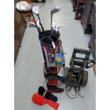 A collection of golf clubs to include a set of 'Wilson' irons in bag with trolley and accessories