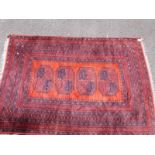 An Turkoman rug on wine red and orange ground with four central guls (196 x 131cm)