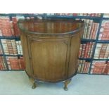 A bow fronted cabinet with two drawers inside,