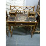 An oriental bamboo and lacquer side table or desk with two small drawers to top and single drawer