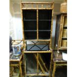 A bamboo and lacquer display cabinet with double door cupboard to top and similar cupboard to base
