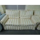 A pair of bespoke gold and cream sofas with goose down cushions,