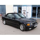 A 1995 BMW 328i convertible, black, with keys,