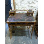 An oriental bamboo and lacquer side table or desk with two small drawers to top and single drawer