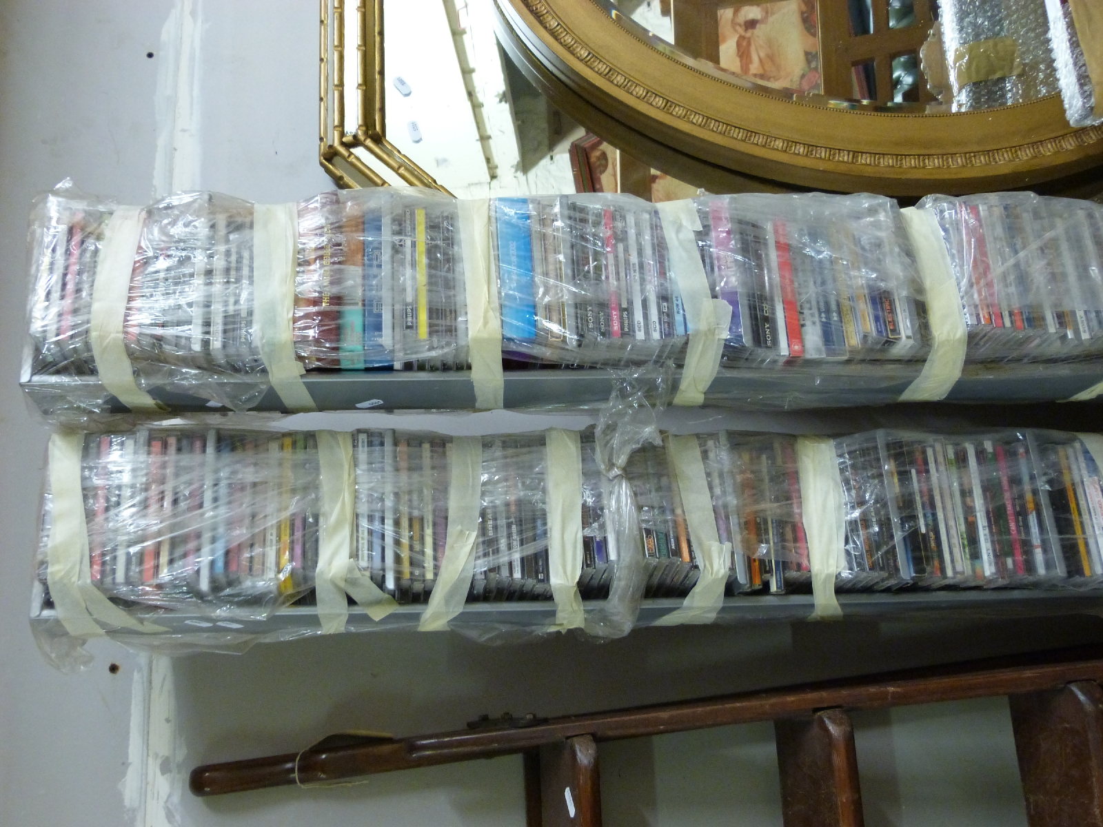 Two tower racks of CDs, mostly 80s/1990s/2000s,
