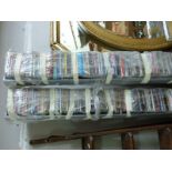 Two tower racks of CDs, mostly 80s/1990s/2000s,