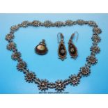 A 19thC cut steel necklace formed of floral links together with a pair of matching earrings and a