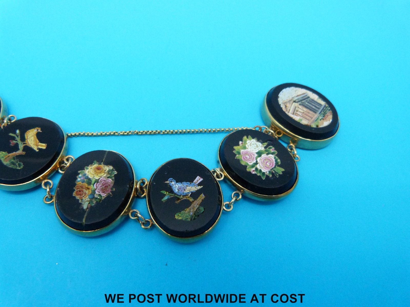 A yellow metal and micro-mosaic bracelet marked 9ct comprising seven oval panels decorated with - Image 2 of 3