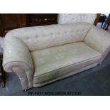 A double drop end upholstered sofa raised on circular mahogany feet.