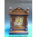 A late 19thC two train mantel clock with carved oak case
