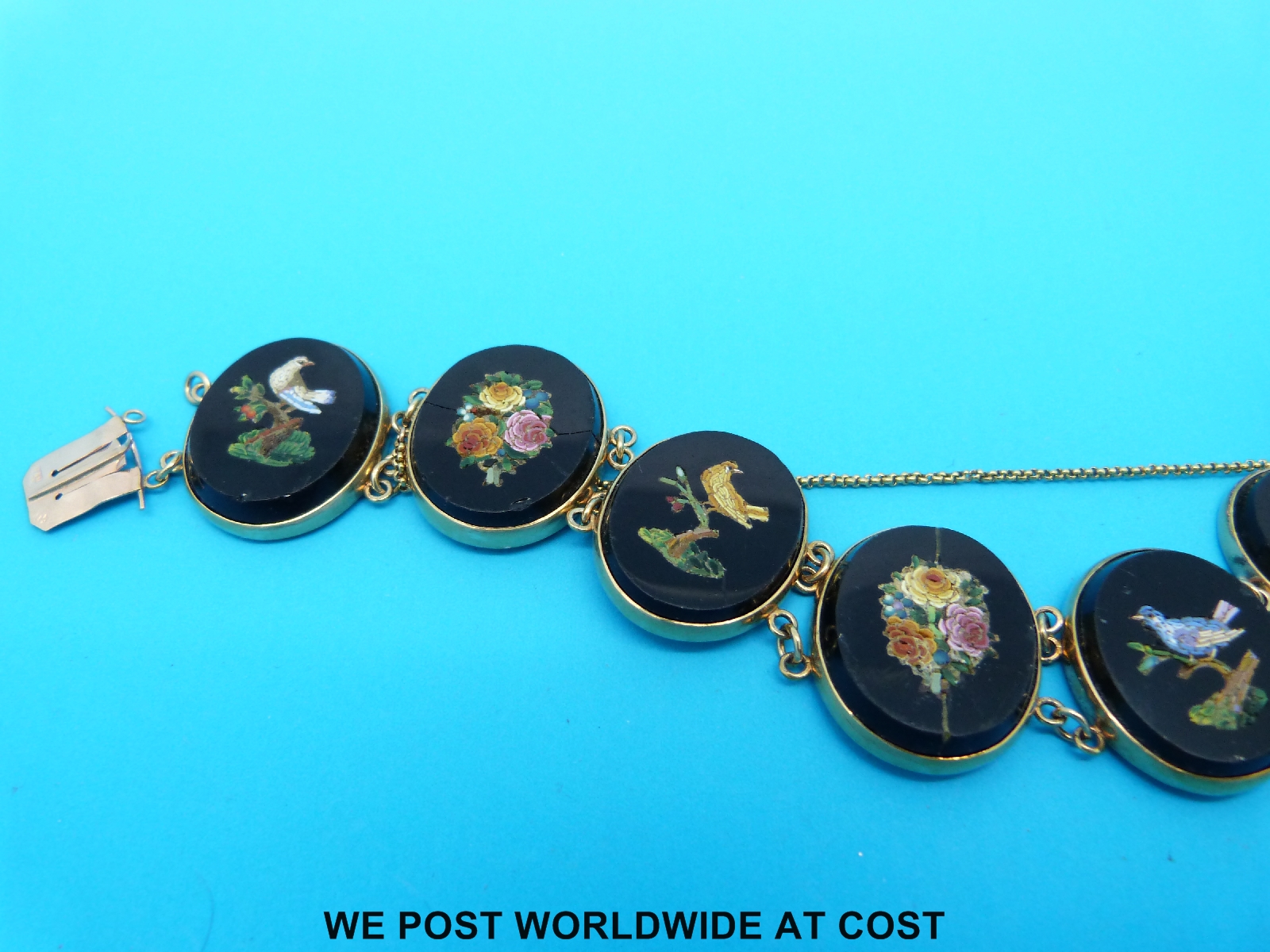 A yellow metal and micro-mosaic bracelet marked 9ct comprising seven oval panels decorated with - Image 3 of 3