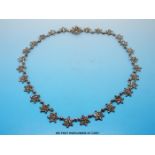 An 19thC cut steel necklace formed of raised floral links