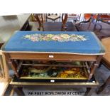 A oak duet piano stool with floral tapestry set and stretcher supports