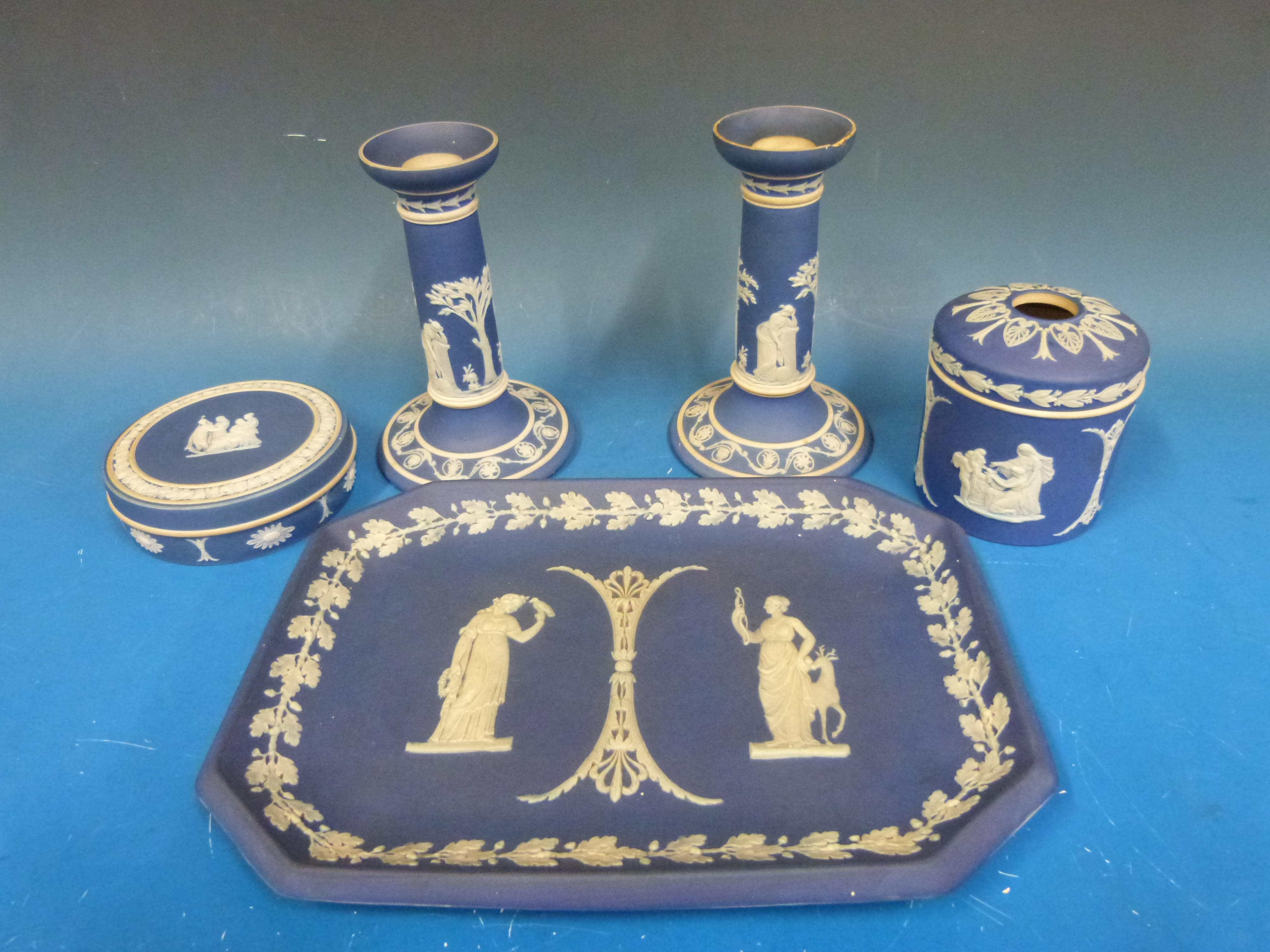 A collection of navy blue Wedgwood Jasperware including a tray, candlesticks,