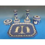A collection of navy blue Wedgwood Jasperware including a tray, candlesticks,