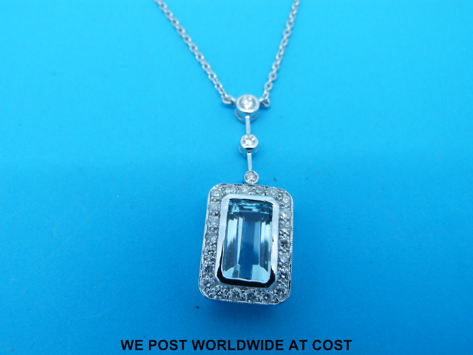 A white metal necklace marked 750 set with an emerald cut aquamarine surrounded by diamonds - Image 2 of 2