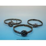 Three Victorian cut steel bangles, one mounted with a fly,