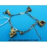 A 9ct gold charm bracelet set with four 9ct gold charms,