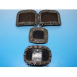 A pair of rectangular cut steel shoe buckles with decoration within a border,