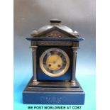 A c1900 slate mantel clock with brass Romanesque decoration,