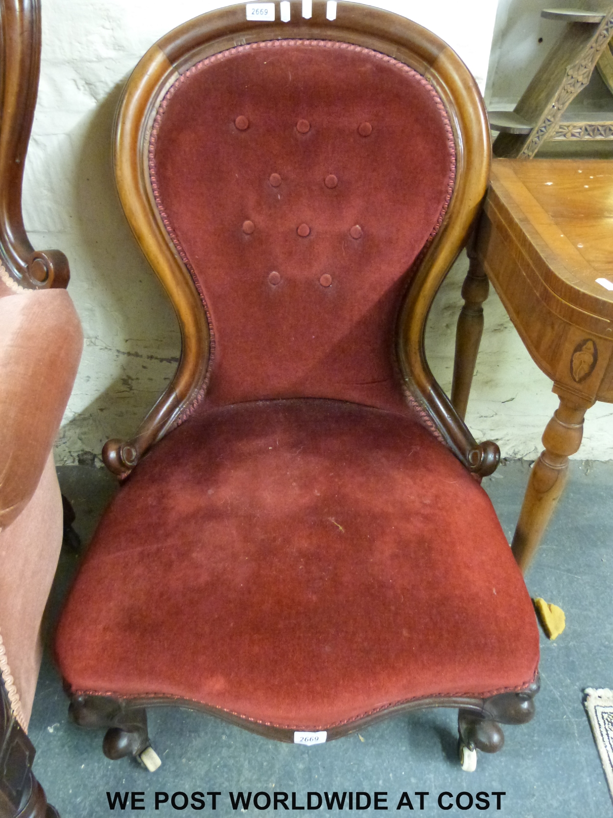 A Victorian mahogany spoon back nursing chair raised on carved cabriole supports