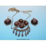 A 19thC cut steel and white metal necklace set with red cabochons,