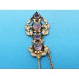 A Diego Percossi Papi designer stick pin set with seed pearls and amethysts amid green and purple