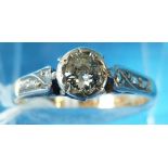 A yellow metal ring marked 18ct set with a round brilliant cut diamond in a platinum setting (size