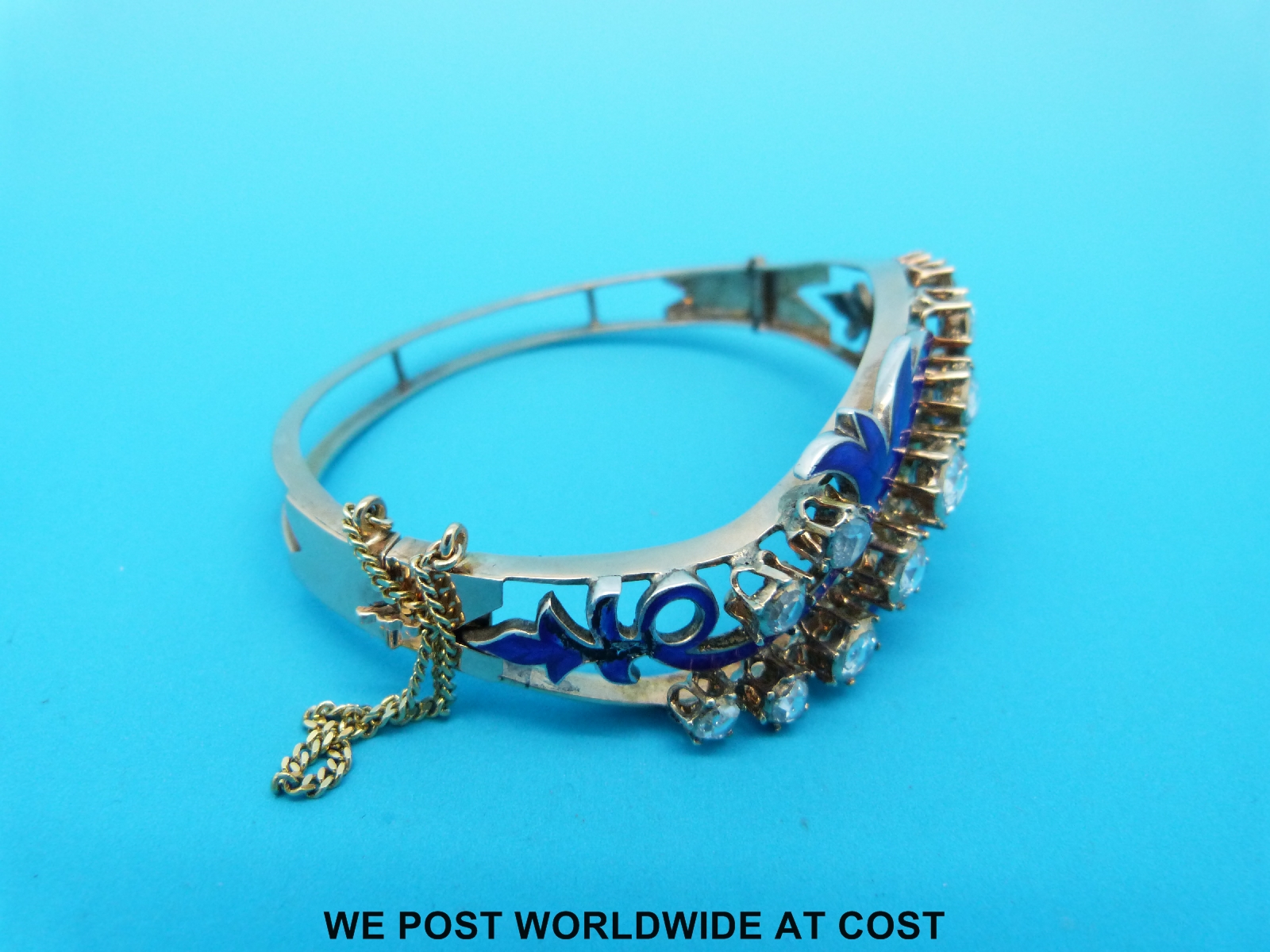 A yellow metal bangle set with 13 rose cut diamonds and blue enamel in a scrolling foliate design - Image 4 of 4