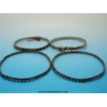 Four Victorian cut steel bangles, two made up of rows of circular faceted stones,