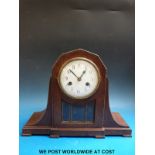 An oak two train c1930 mantel clock with glass-panelled door