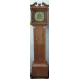 An oak 30 hour longcase clock with brass dial and single hand.