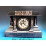 A large slate mantel clock with columns and Brocot visible escapement and two train movement marked