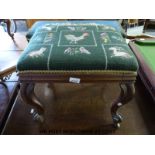 A Victorian mahogany upholstered stool raised on brass castors