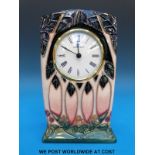 A Moorcroft mantel clock in the Cluny pattern (15cm tall)