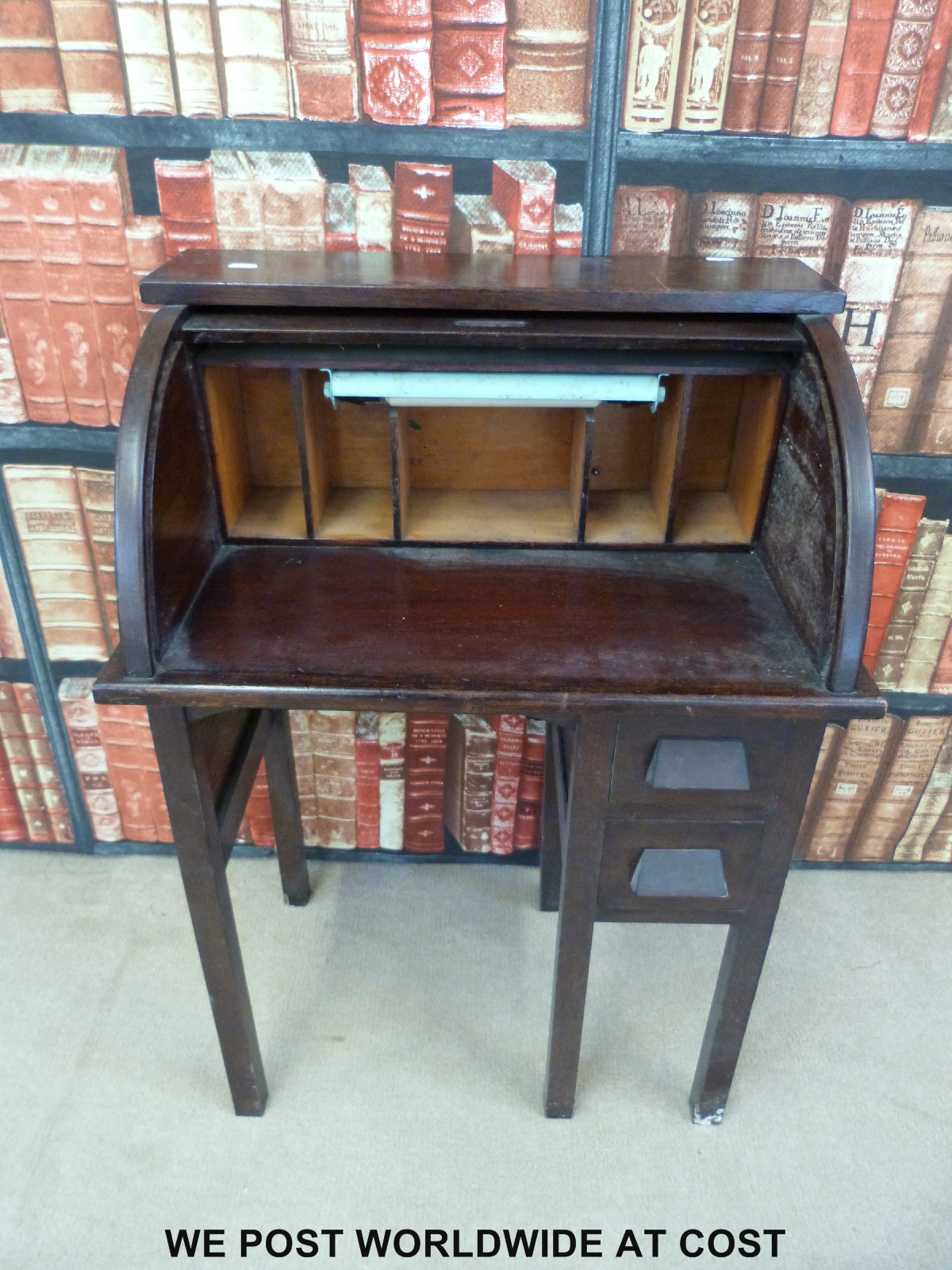 An oak roll top desk of unusually small proportions (h88cm x w60cm x d38cm)