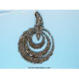 A 19thC cut steel pendant formed of three loops with crescent detail