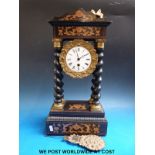 A Victorian ebonised and gilt decorated mantel timepiece raised on four barley twist supports,