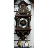 A German weight-driven wall clock with brass decoration,